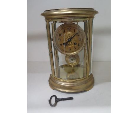 A French oval four glass mantle clock, 27.5cm tall x 19cm wide, striking on a single gong, in good working order, glass good 