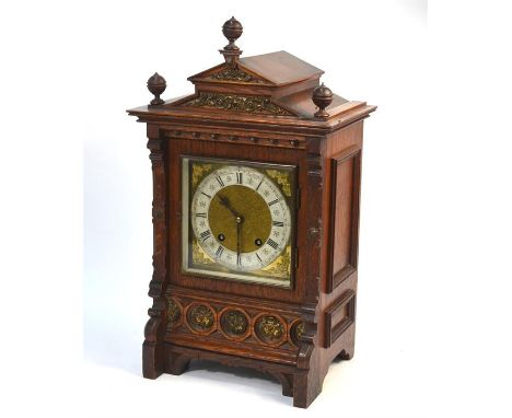 A 19th century German oak architectural cased 8-day mantel clock, the two train movement striking on a twin hammer spiral gon