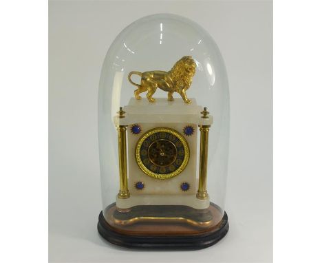 A 19th century alabaster mantel clock, surmounted by a gilt spelter lion, the blue/gilt dial flanked by conforming roundels t