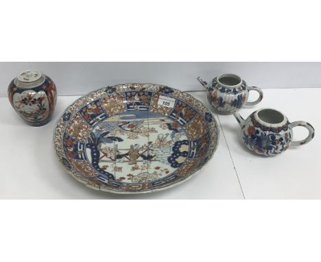 A 19th Century Japanese Meiji period Imari bowl with shaped edge, the centre field decorated with figures and dogs in a garde