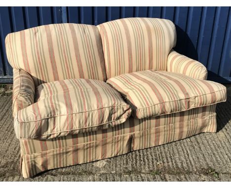 A modern striped upholstered two seat sofa in the style of Howard of London, on square tapered stained beech front legs to ca
