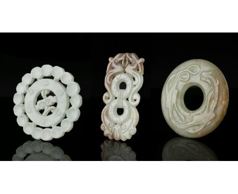 A GROUP OF THREE (3) JADE CARVINGS China The first one is an open-worked 'ruyi' plaque. The second one is carved with two con