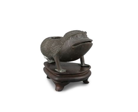 A BRONZE 'THREE-LEGGED TOAD' INCENSE BURNER  China, Late Ming Dynasty  The beast standing three squares, its back with a hole