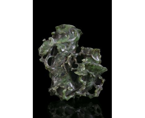 AN HIBISCUS SHAPED SPINACH JADE DOUBLE VASE China, Qing Dynasty, 19th centur Carved in a green stone with darker inclusions w