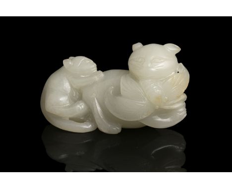 A WHITE JADE GROUP OF TWO CATS WITH A BUTTERFLY 玉耄耋 China, Qing Dynasty Carved out of an almost flawless stone with a recumbe