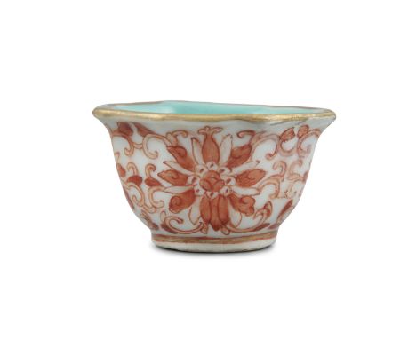 A SMALL IRON RED PORCELAIN 'LOTUS' WINE CUP China, Qing Dynasty, 19th century The base inscribed with the seal mark of Empero