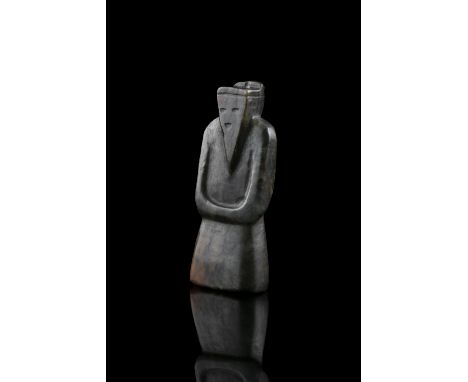 A BROWN 'WENG ZHONG 翁仲' SERPENTINE / SOAPSTONE PENDANT China The abstract standing figure dressed in long robes, the solemn f