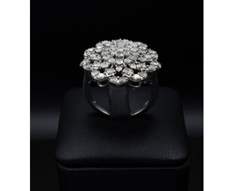 A DIAMOND CLUSTER COCKTAIL RING, with an intertwined design of approximately 61 round brilliant cut diamonds, gallery setting