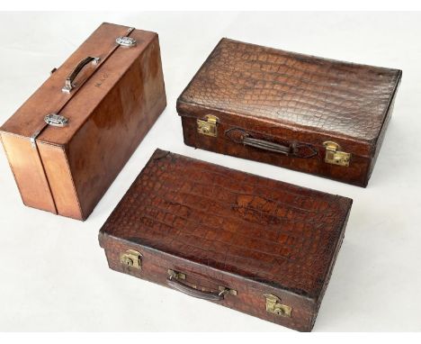 SUITCASES,  two, vintage crocodile with gilt brass mounts together with a leather fitted shoe case. (3)