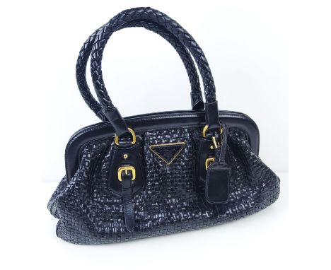 PRADA HANDBAG, black weaved leather, gold tone hardware and bottom feet, two top handles, name tag, fabric lining, 39cm x 14c