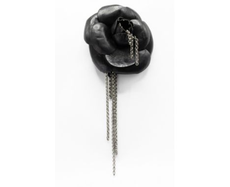 CHANEL BROOCH, iconic camellia flower in black distressed calfskin leather and gun metal tone accents, with safety pin closur