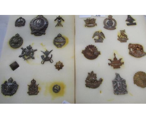 Two sheets of British, Commonwealth and European military cap badges, including naval interest, including Nelson, Howe, Porte
