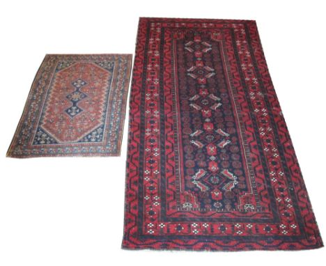 VINTAGE BALUCH CARPET, 260cm x 127cm, and an antique Qasqai rug, 123cm x 88cm.