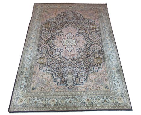 FINE KASHMIR PURE SILK CARPET, 263cm x 178cm, floral medallion on a midnight blue field of flowerheads and vines inside corre