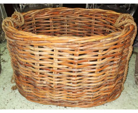 LOG BASKET, vintage wicker of substantial size, oval, with rope handles, 103cm W x 64cm H x 72cm. 