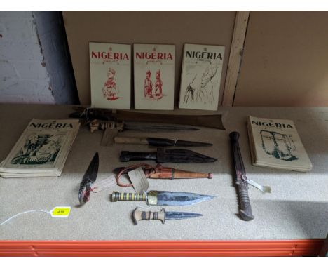 A group of African daggers and a machete, some in leather sheaths, circa 1940 and a group of Nigerian quarterly magazines cir