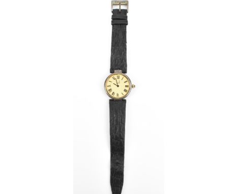 A Dunhill, quartz, ladies, silver gilt wristwatch, having a textured gilt dial, Roman numerals, on a original black leather s