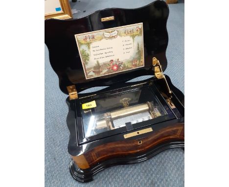 A late 20th Century Reuge music box  in a walnut and mixed wooden case playing 4 songs. Location:RAM 