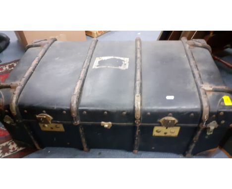 An early 20th Century steamer trunk having treen strapwork and leather reinforced corners with interior removable tray shelf.