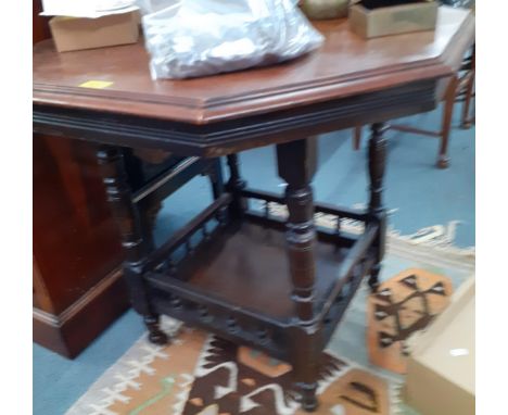 An early 20th century occasional table with galleried shelf below and another 