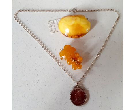 A Modernist Baltic butterscotch amber brooch and a Welsh amber and gold plated brooch fashioned as a bunch of grapes together