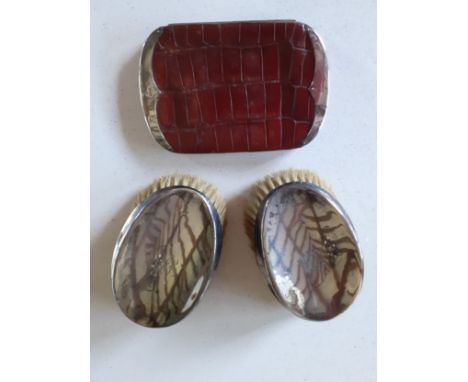 Two silver hand brushes and a Circa 1900 brown crocodile wallet with silver bat wing ends stamped with the makers initials F.
