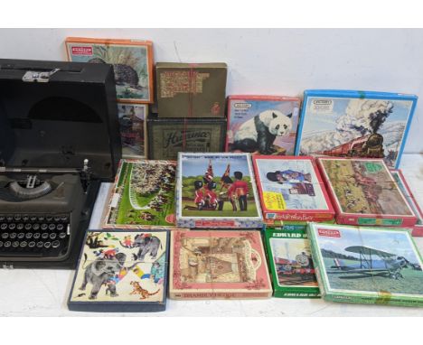 A selection of boxed puzzles to include Bramley Hedge, Victory and others, together with an Imperial typewriter Location: 