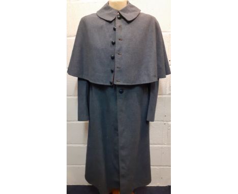 A 1950's blue woollen coat in the style of a Staunton Military Academy overcoat, 40" chest x 45" long with integrated cape to