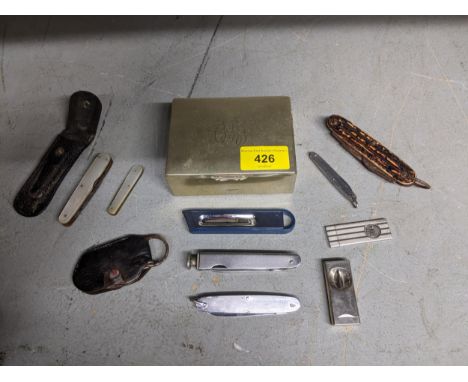 A group of pen fruit knives, cigar cutters, penknives, and a silver plated cigarette box Location: 