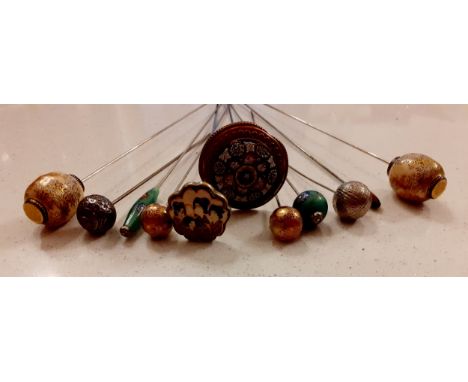 Early 20th Century Oriental hat pins to include Satsuma glazed enamel examples, a pair of white metal examples together with 