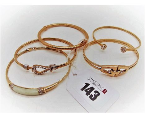 A 9ct Gold Bangle, with loop and hook fastener; together with a hinged bangle, of textured finish; a modern bangle of geometr