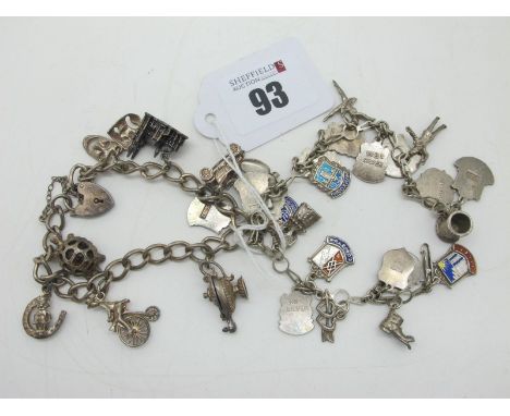 A Curb Link Charm Bracelet, suspending assorted novelty charm pendants; together with another bracelet, suspending souvenir e