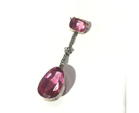 A striking pink glass/paste pendant, probably c. 1920, the large teardrop-cut pendent "stone" millegrain set and suspended fr