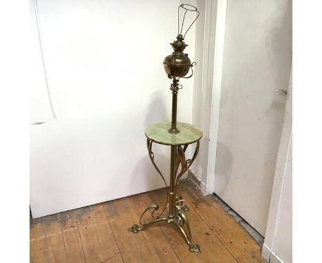 A striking brass and onyx floor lamp, c. 1900, in the Art Nouveau taste, converted from an oil lamp, the brass reservoir on a