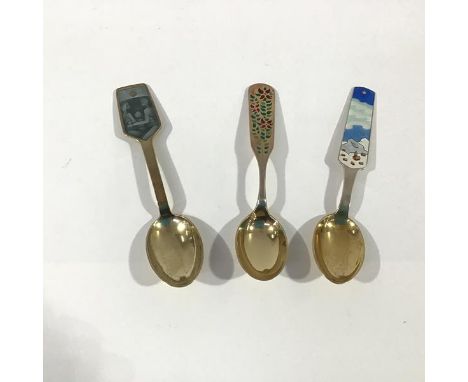 A group of three Danish sterling silver and enamel Christmas spoons by A. Michelsen, Copenhagen: 1955, the handle enamelled i
