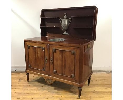 An 19th century French Transitional gilt-metal mounted mahogany combination commode and travelling washstand, the hinged cros