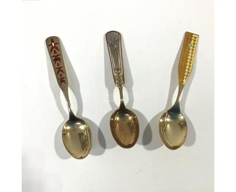 A group of three Danish sterling silver and enamel Christmas spoons by A. Michelsen, Copenhagen: 1937, the pierced handle wit
