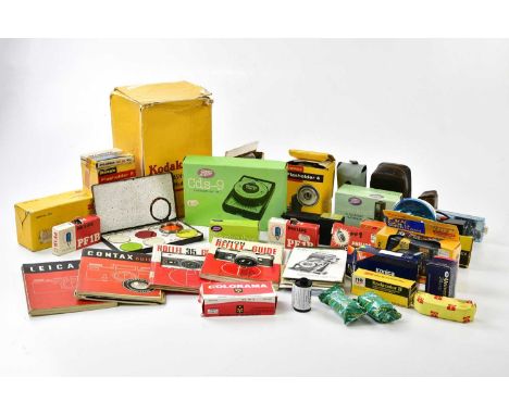 A collection of film photography accessories, to include light meters, flash bulbs, manuals, guides and rolls of expired film
