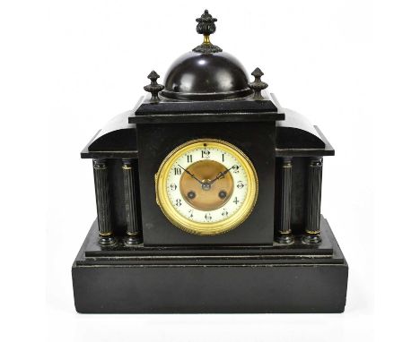 A Victorian slate mantel clock with three finials and dome top above the dial set with Arabic numerals, height 36cm.
