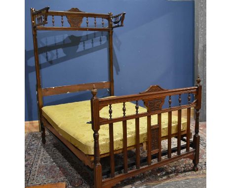 An Edwardian double bedstead, with carved footboard and headboard, height 215cm, length 187cm.