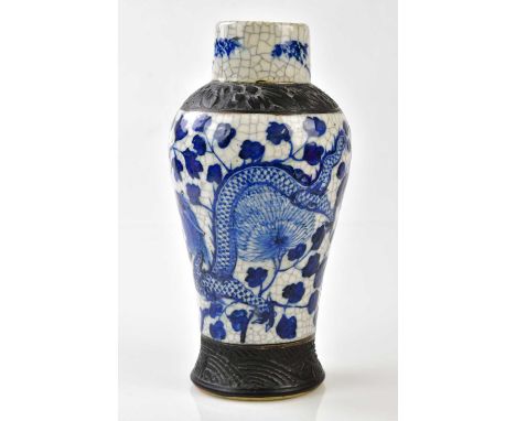 An early 20th century Chinese crackle glazed blue and white vase decorated with a four claw dragon, impressed seal mark to ei