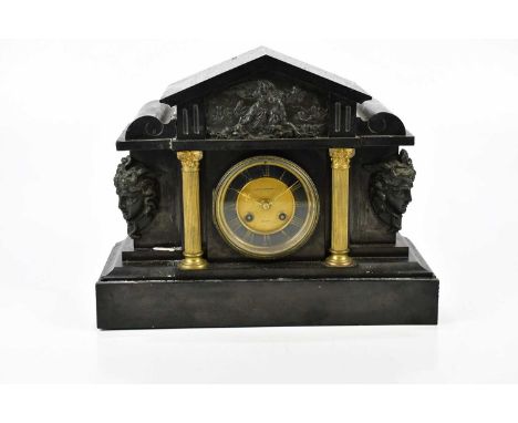 A Victorian slate mantel clock of architectural form with applied plaque of a maiden beside bull and a pair of mask heads fla