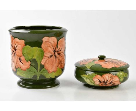 MOORCROFT; a jardinière in the 'Coral Hibiscus' pattern on a green ground, height 17cm, and a powder bowl and cover in the sa