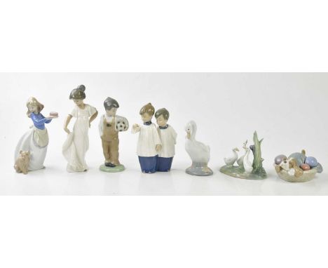 NAO; four figures and three models including a boy standing holding a football, height 19cm, a pair of choir boys, a puppy in