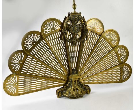 A green painted cast iron stick stand, height 61cm, and a brass fan effect fire screen (2).