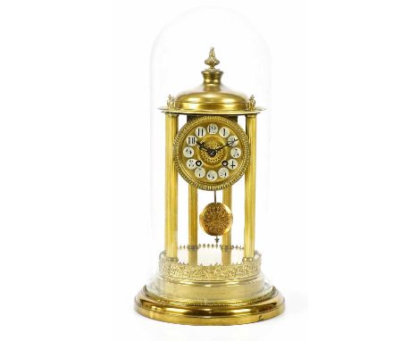 An early 20th century brass anniversary clock of cylindrical form, with applied finials above the dial set with Arabic numera