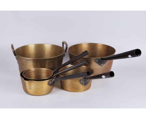 A group of vintage brass cooking pans with iron handles plus heavily cast preserve pan with brass handles