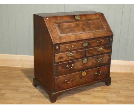 A George III Yew wood bureau, with classical cascade fitted interior over a two drawer base on bracket feet 96cm width