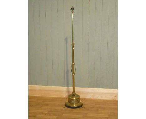 Edwardian brass standard lamp with heavy Bonnet shaped base on three feet, no shade. 120cm high, base 34cm diameter
