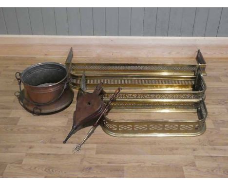 Four assorted graduated brass hearth fenders together with copper log bin, toasting fork and bellows